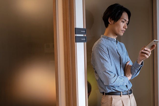 スマートフォンを見て難しい表情をしている男性のイメージ